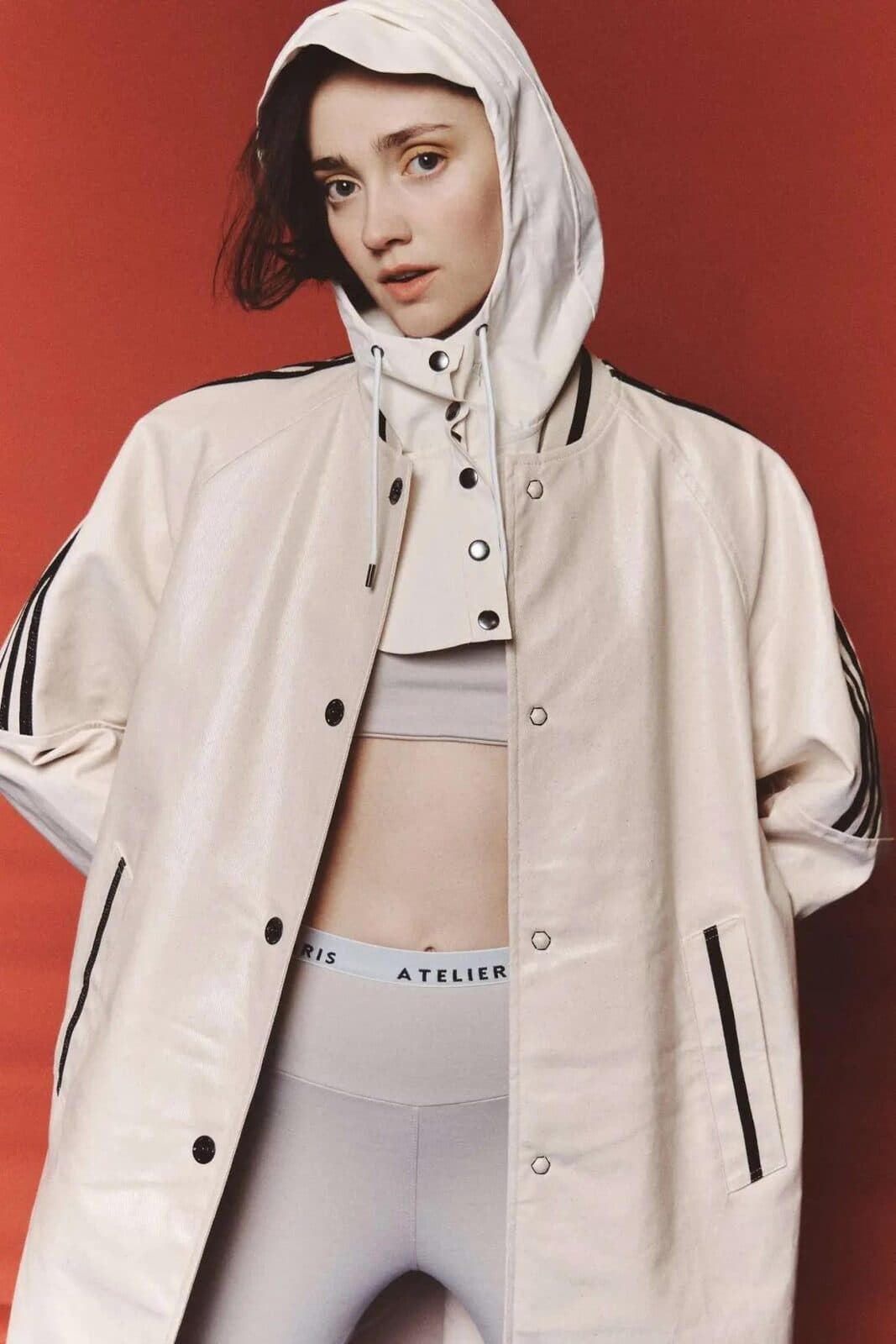 Who's Next campaign image, model in a hooded jacket against a red backdrop