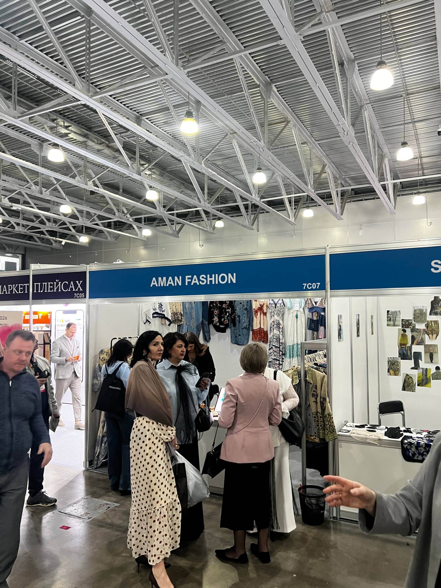 An Indian apparel brand's stand at Interfabric Moscow with Russian buyers viewing the collection.