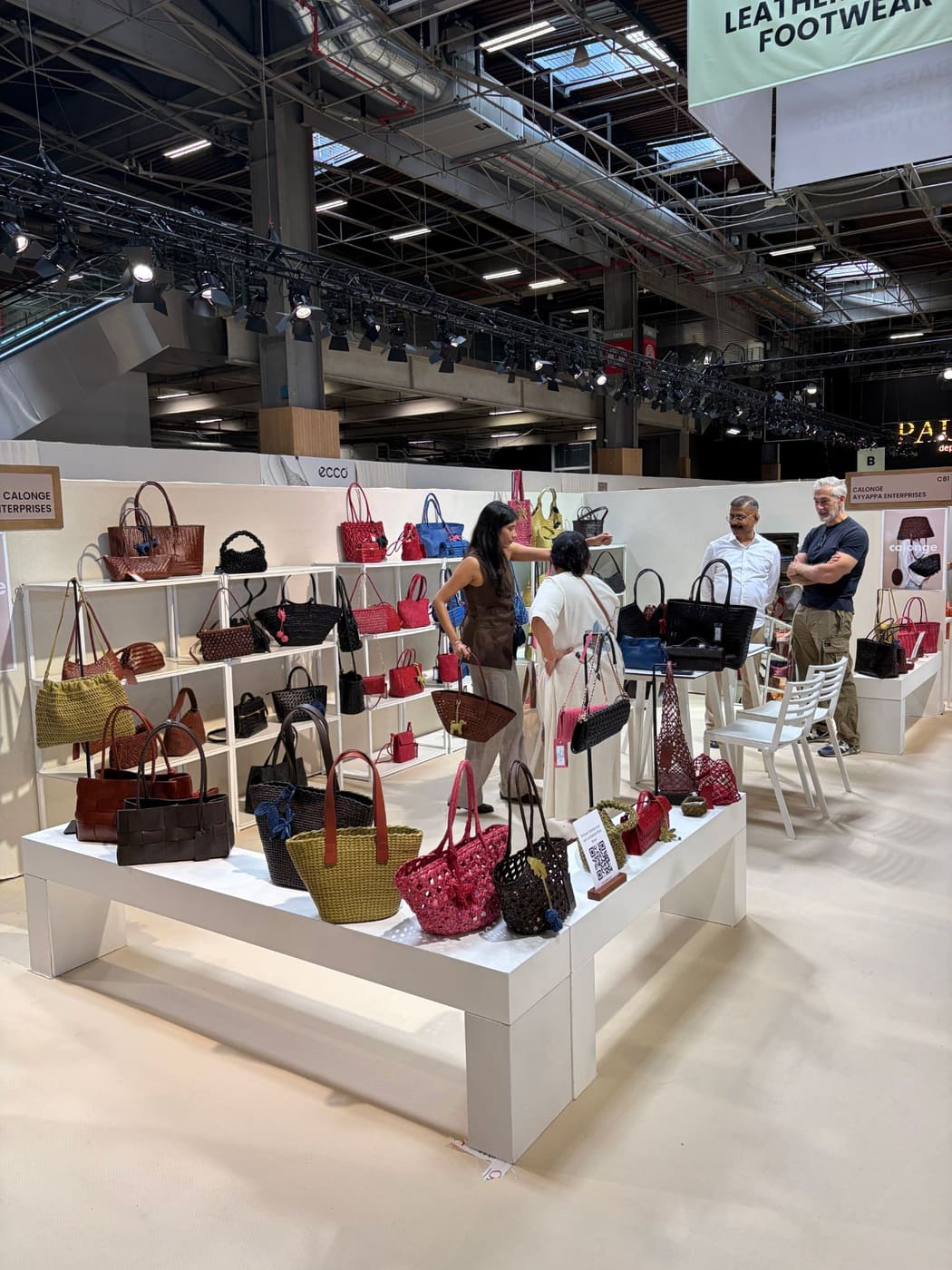 Buyers looking at woven leather bags on the Calonge stand, C81, in the bags, leather goods and footwear sector at Who's Next September 2026.