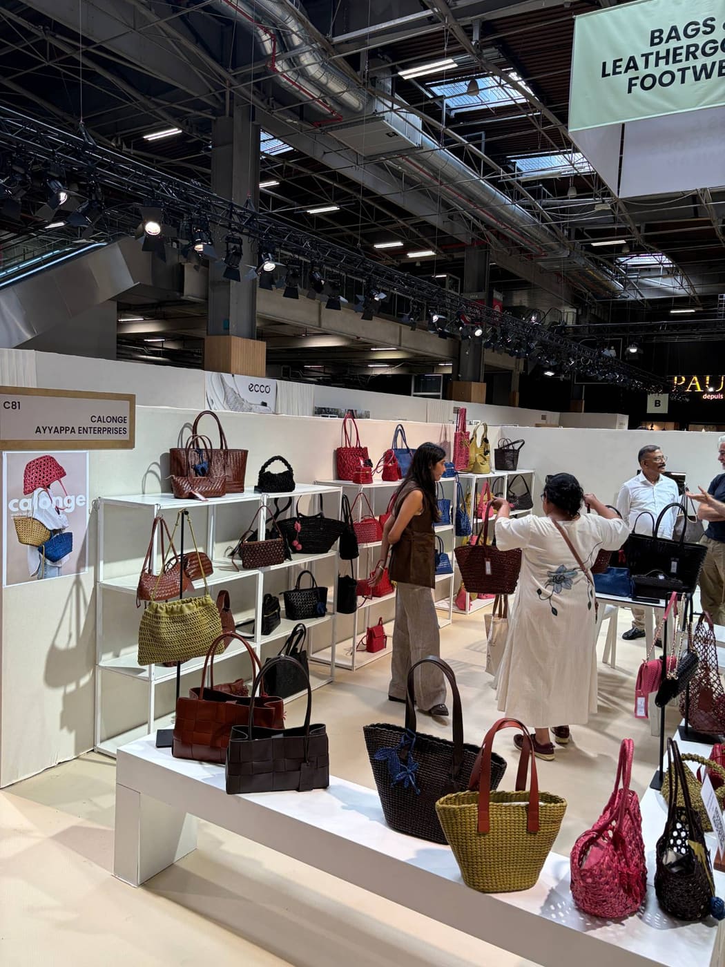 Buyers looking through bags on the Calonge stand in the bags and leather goods sector at Who's Next Paris, September 2026.