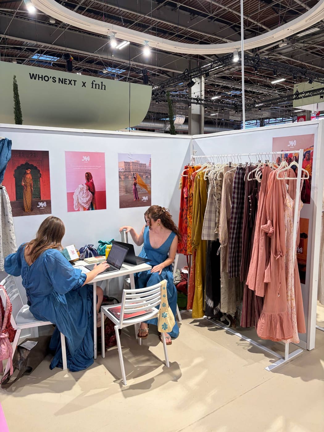 Saheli Women stand B36 at Who's Next September 2026, with campaign posters about empowering women artisans behind the table.